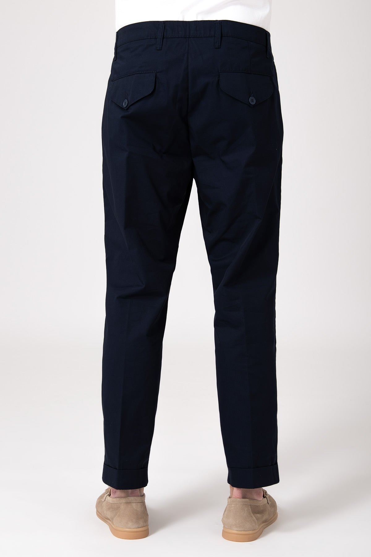 Man wearing blue high-waisted pants with darts rear view