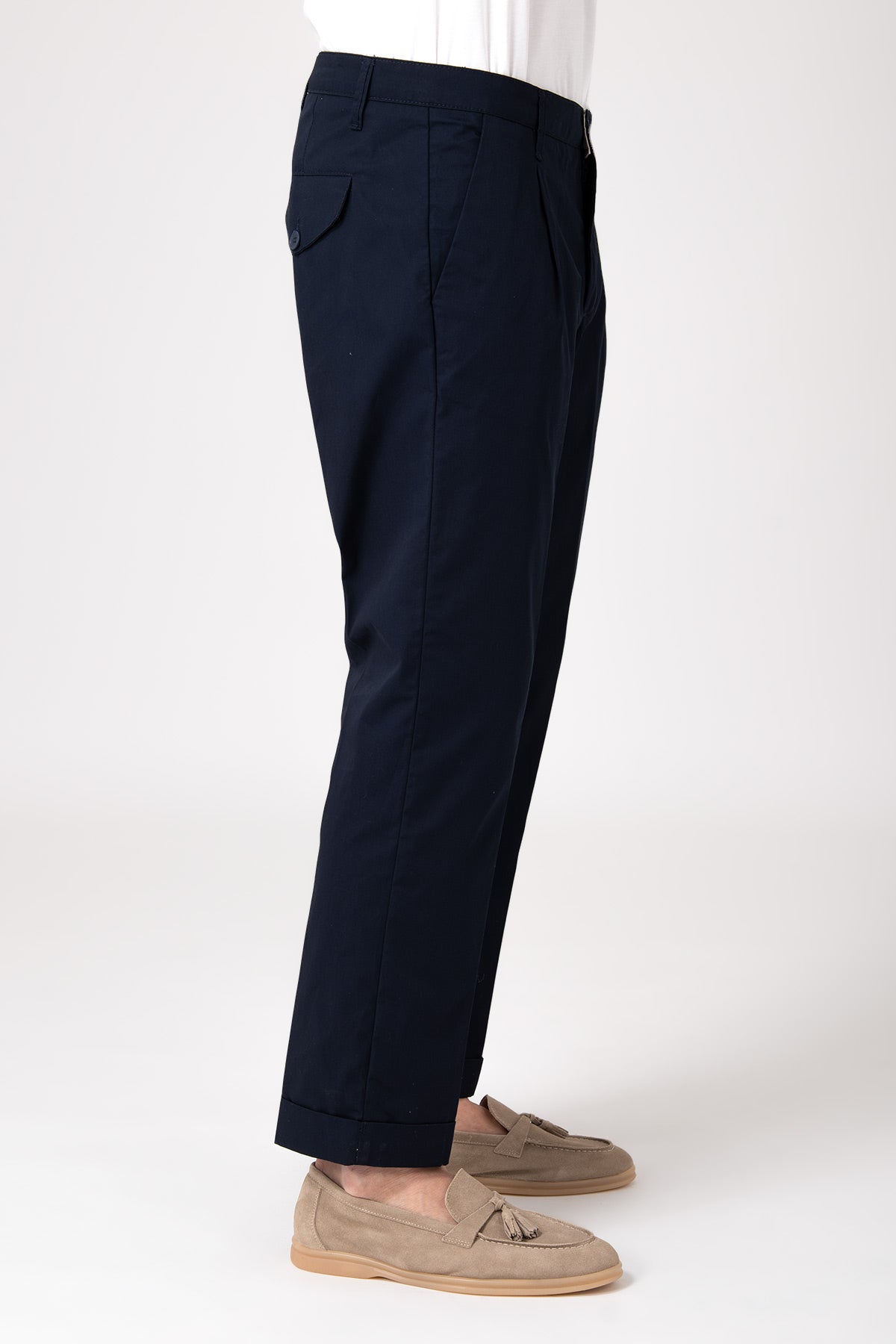 Side view of model wearing blue high-waisted pants with darts