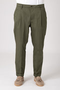 Man wearing green high-waisted pleated trousers front view