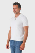 White short-sleeve cotton polo shirt viewed from the side