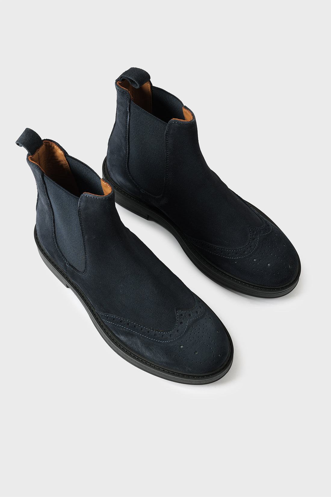 Pair of blue suede Chelsea boots with elastic inserts and brogue detailing