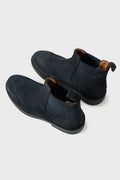 Blue suede Chelsea boots with elastic side panels and brogue detailing, high three-quarter view