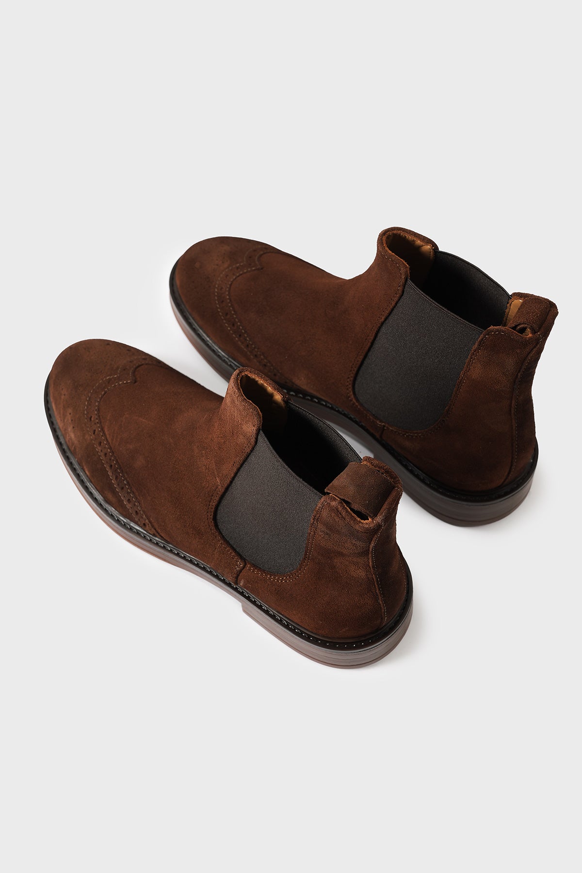 High-angle three-quarter view of cigar brown suede Chelsea boots