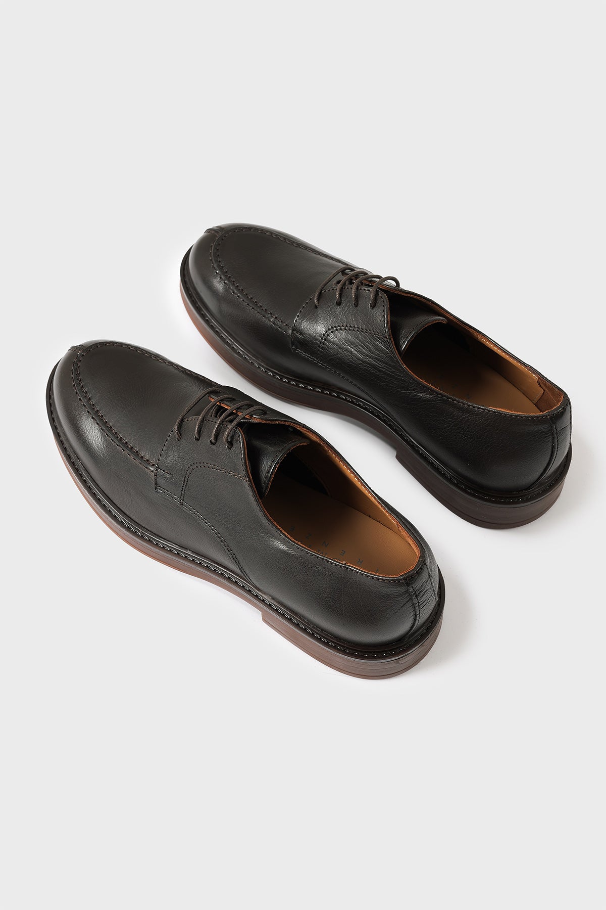 Three-quarter view from above of dark brown leather Norwegian derby shoes