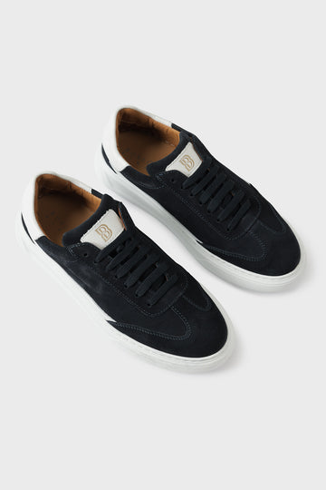 Low-top blue suede trainers with a white cupsole and lace-up front