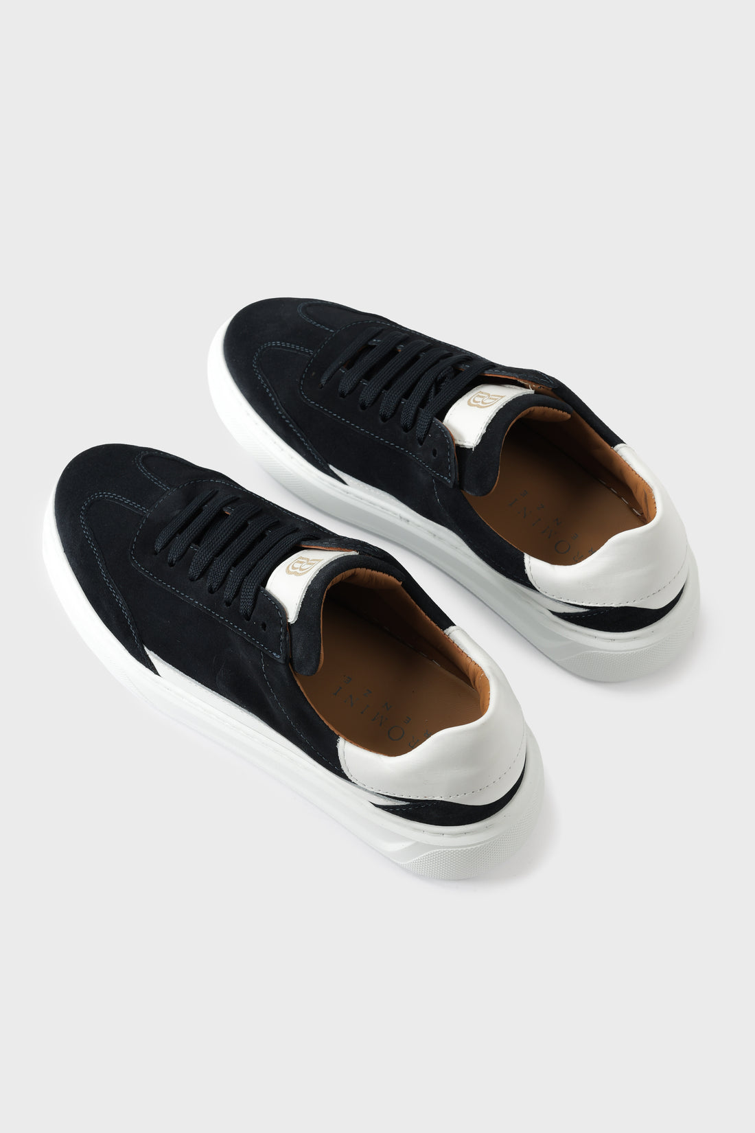 Low-top blue suede trainers with a white cupsole and lace-up front