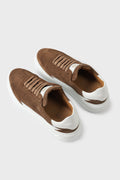 Top view of a pair of tobacco brown suede sneakers with white cupsoles