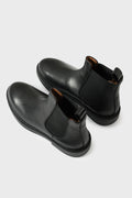 Three-quarter view from above of black leather Chelsea boots