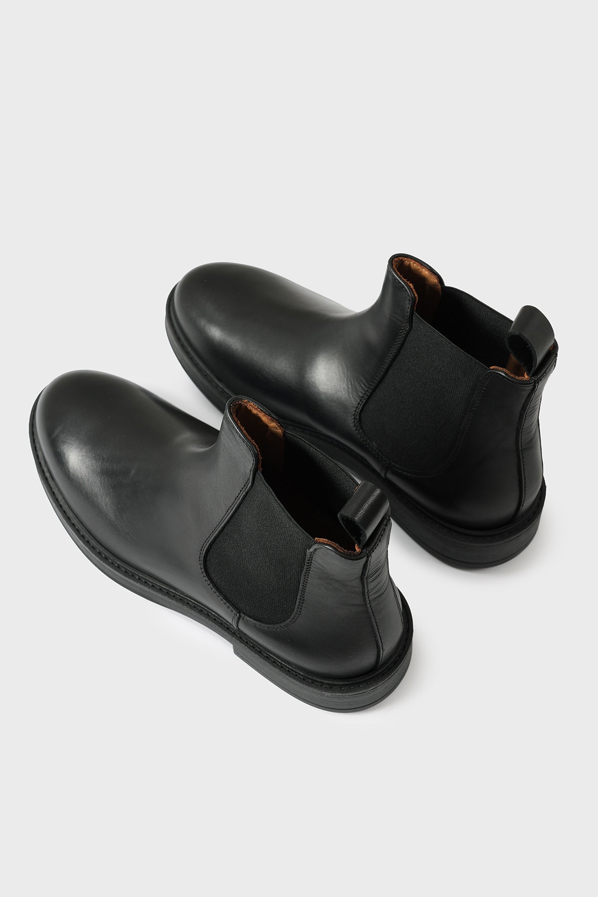 Three-quarter view from above of black leather Chelsea boots
