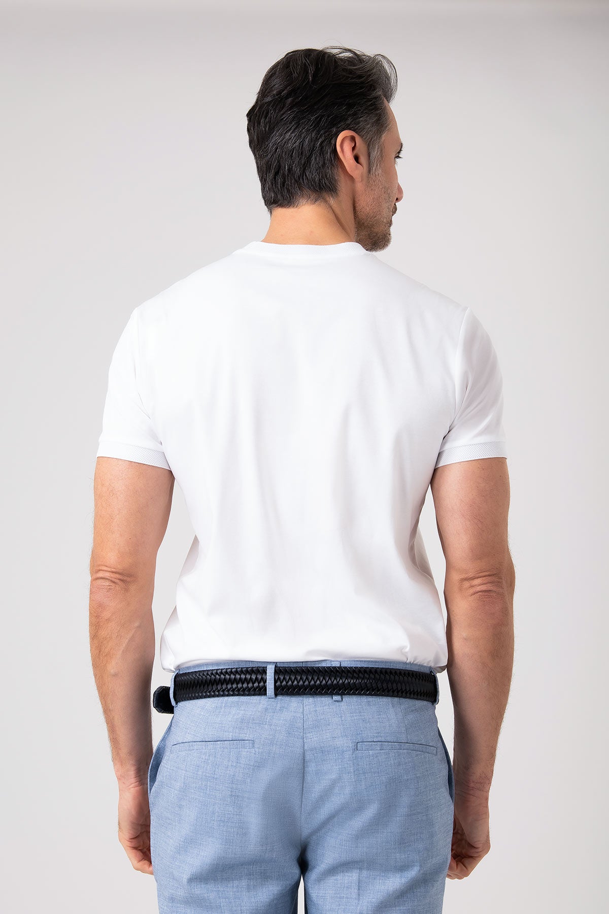 Man wearing white mercerized cotton T-shirt viewed from behind