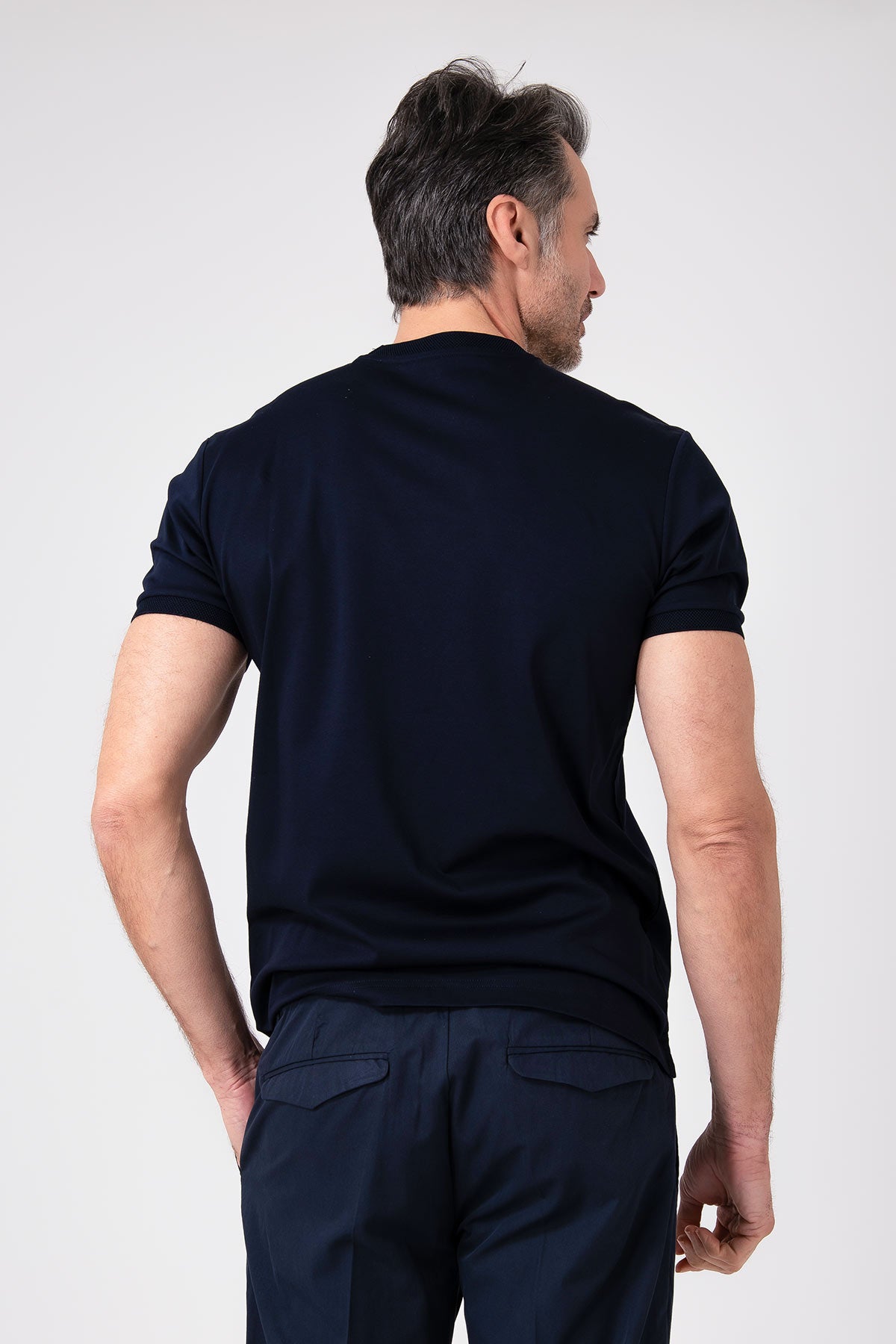 Man wearing navy blue mercerized cotton t-shirt back view