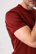 Close-up side view of man wearing brick colored mercerized cotton T-shirt