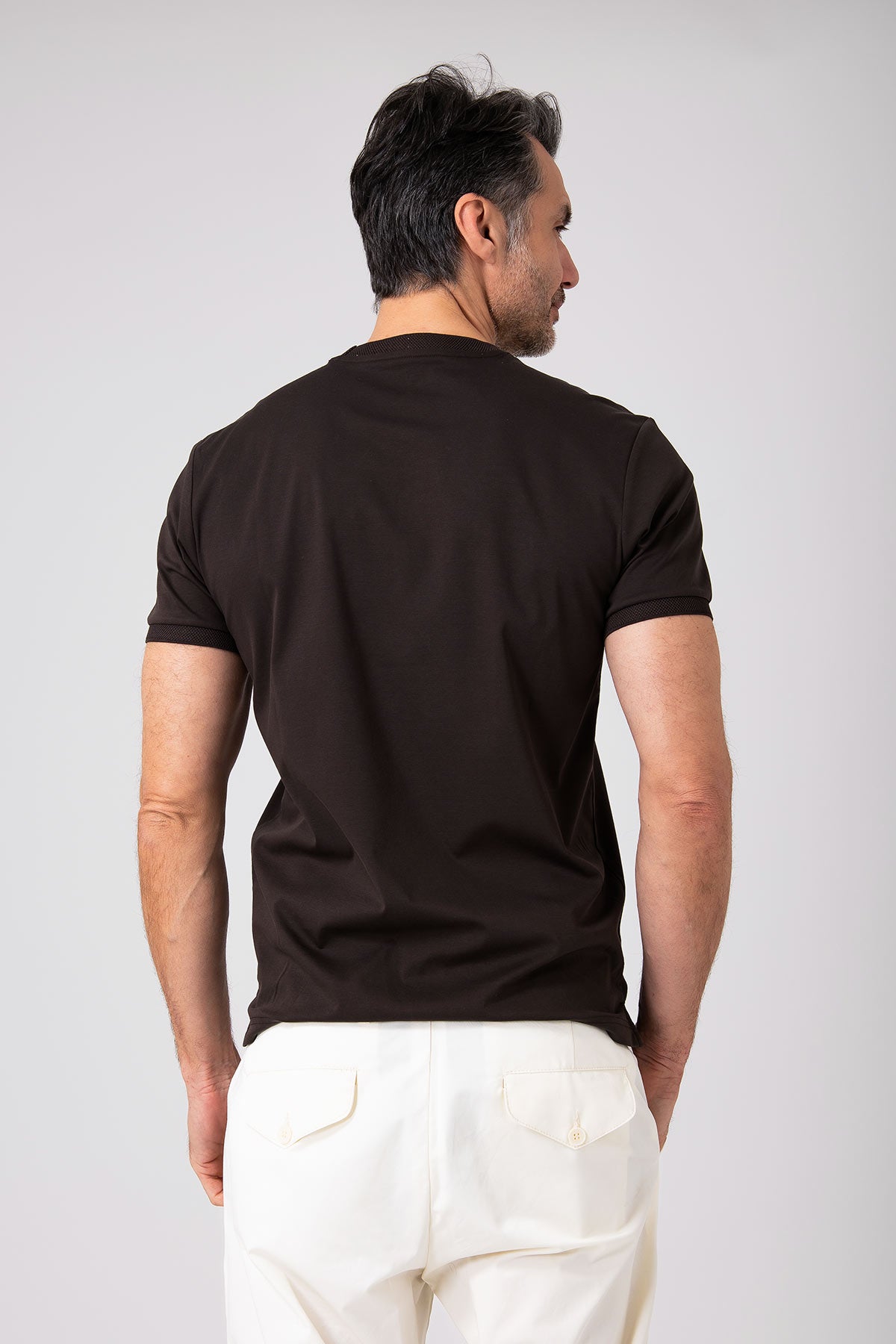 Man wearing black mercerized cotton T-shirt back view