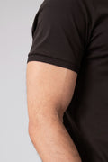 Close-up side view of a man wearing black mercerized cotton T-shirt showing short sleeve detail