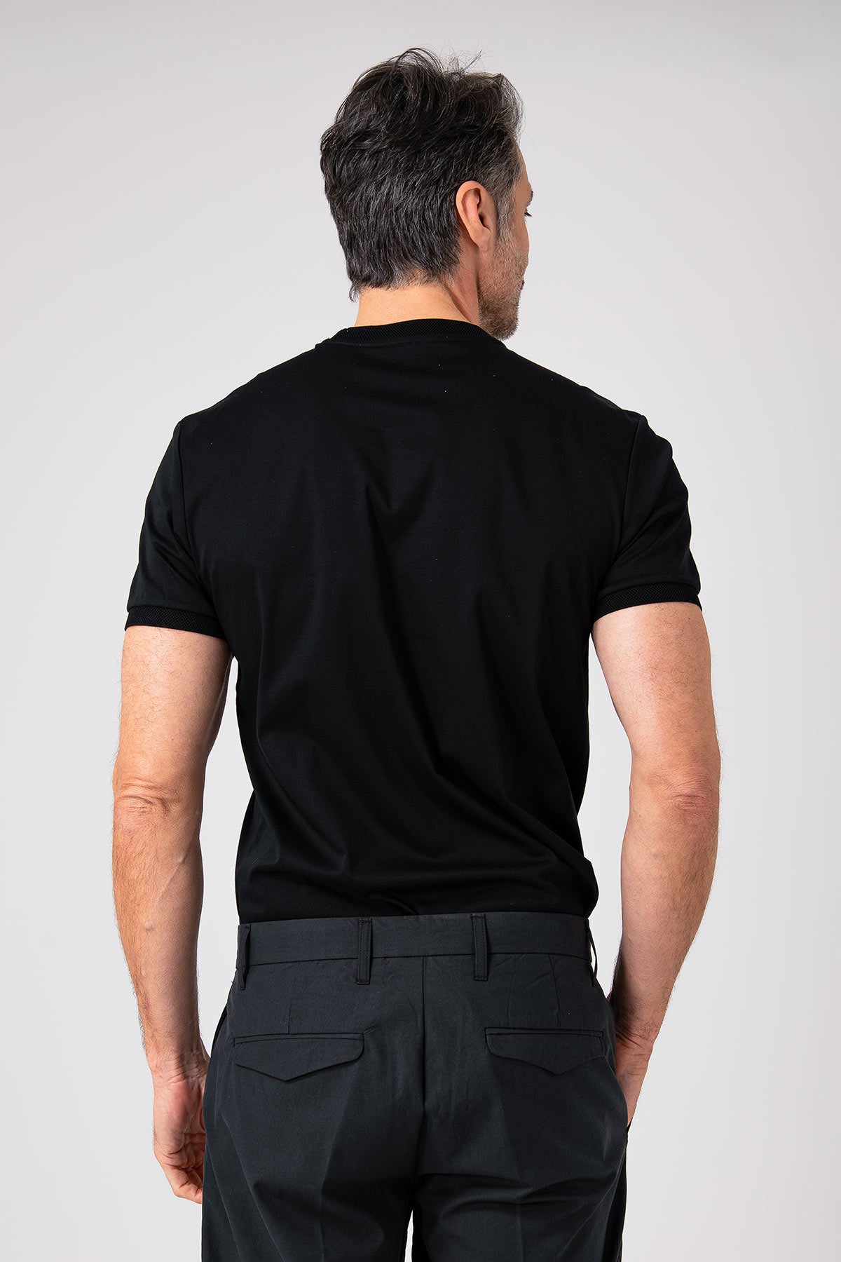 Man wearing black mercerized cotton T-shirt back view