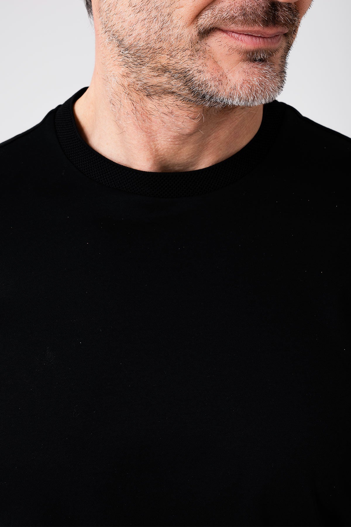 Front close-up of man wearing black mercerized cotton T-shirt
