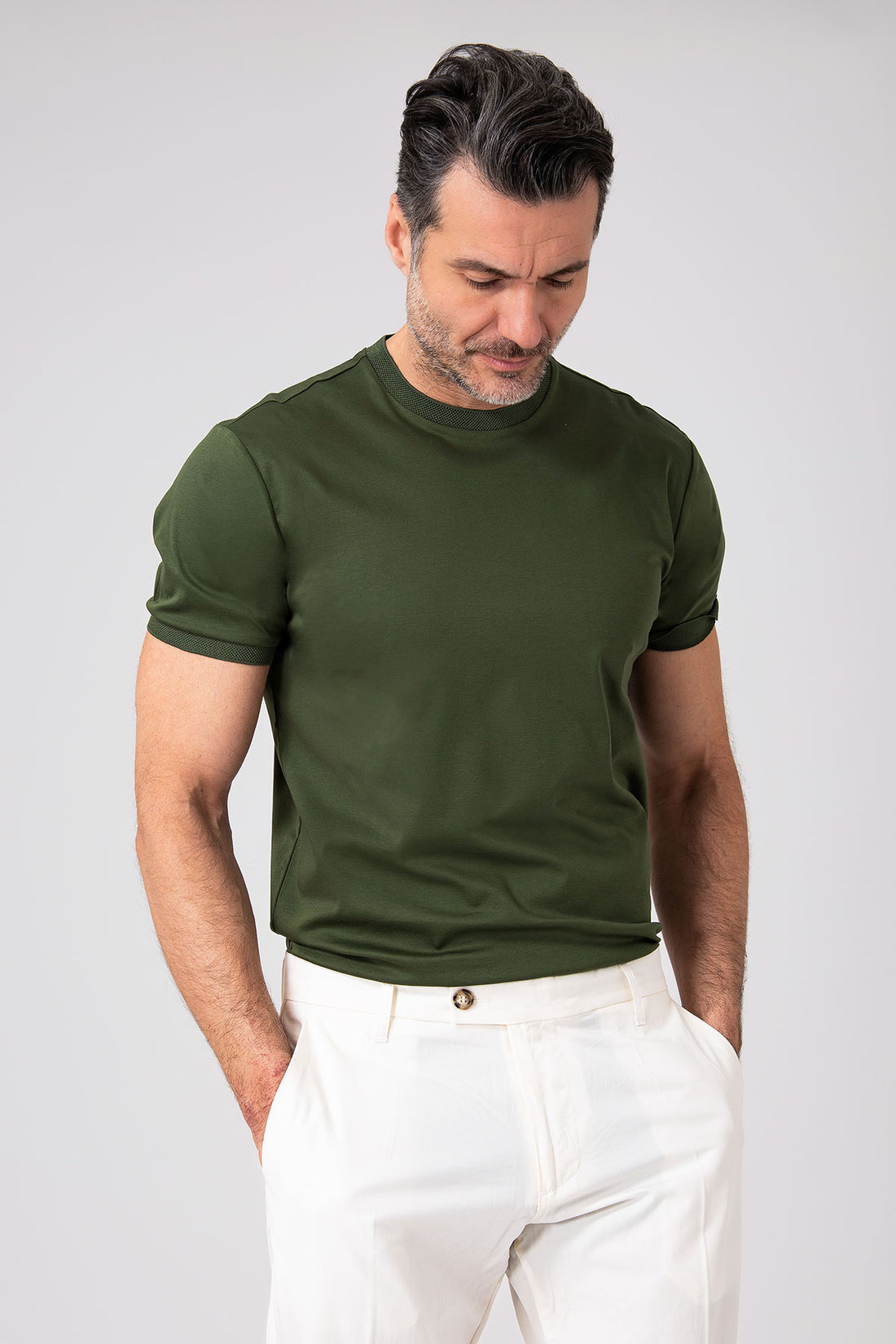 Man wearing a green mercerized cotton T-shirt front view with short sleeves and neck insert