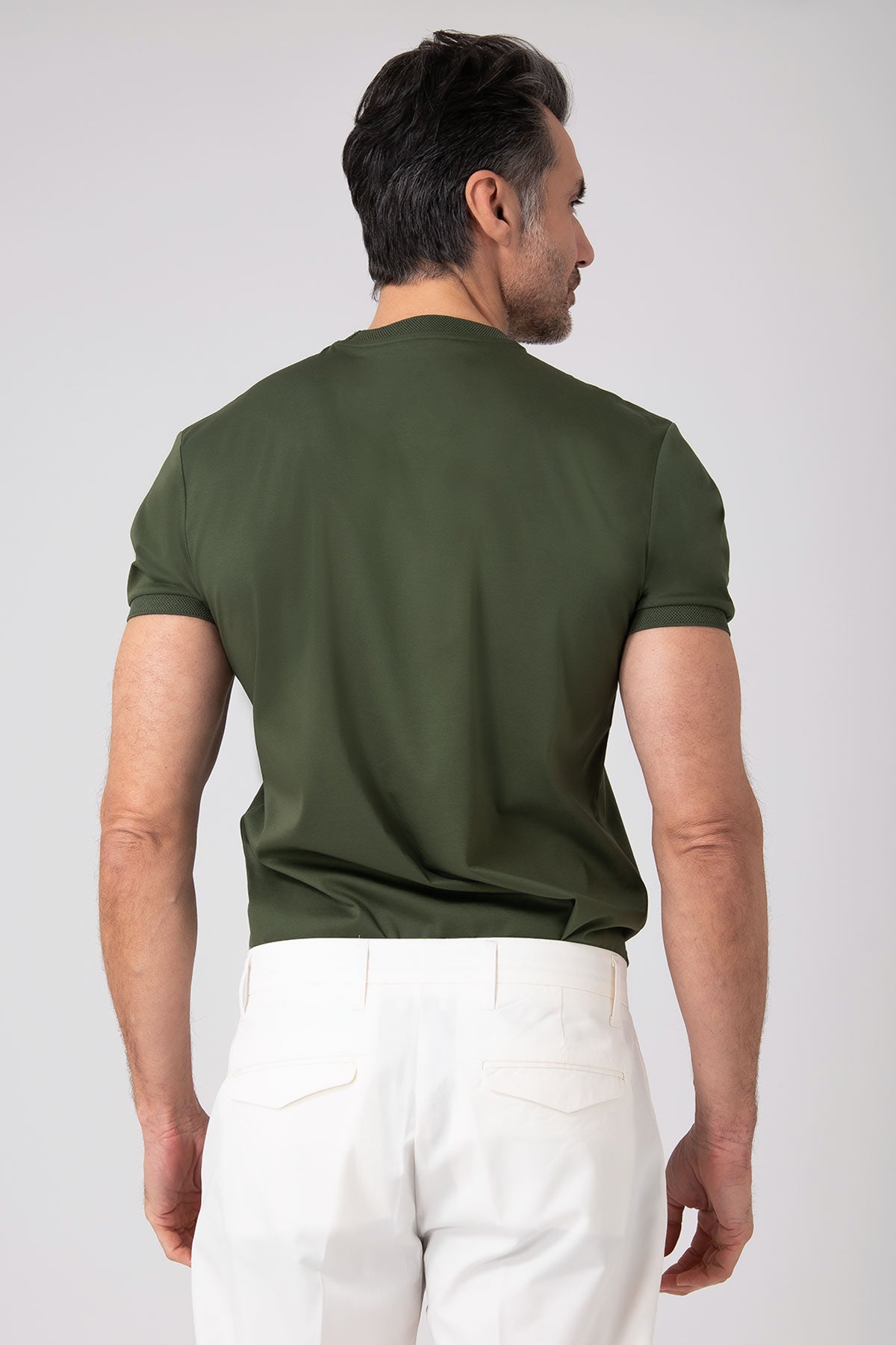 Green mercerized cotton T-shirt worn by a man seen from the back
