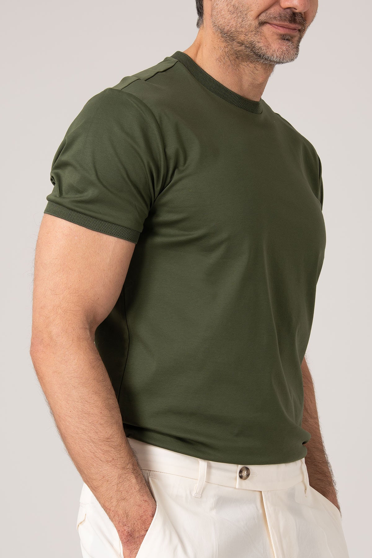 Man wearing green mercerized cotton t-shirt side view